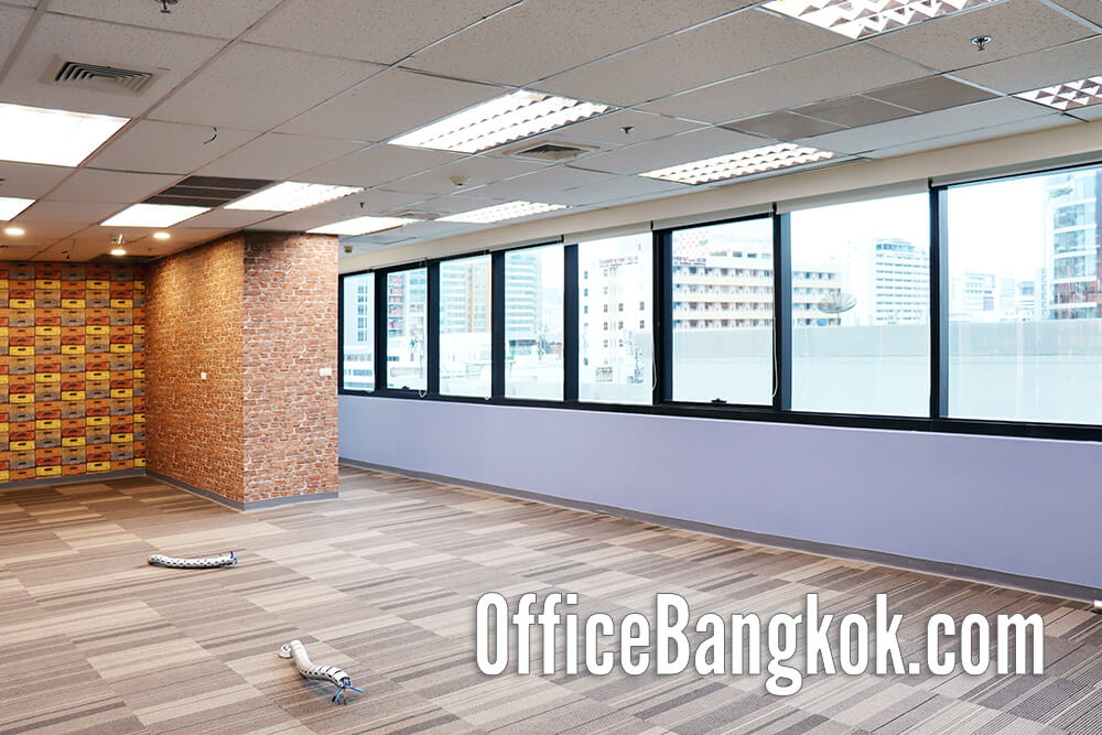 Spacious partly furnished office for rent near BTS Chidlom, featuring natural light, private meeting rooms, and a professional working atmosphere.