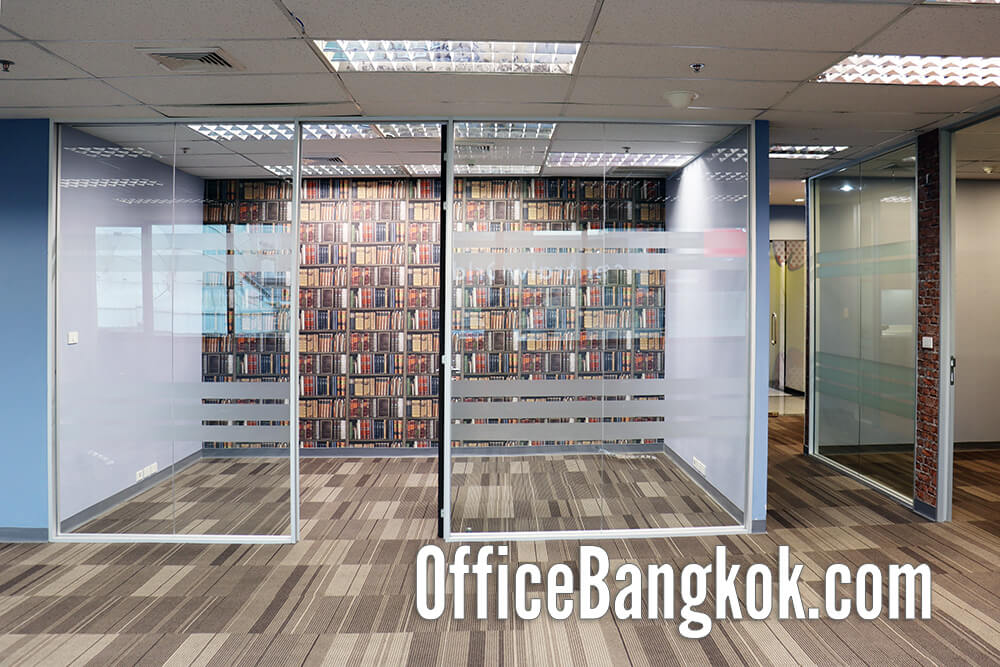 Spacious partly furnished office for rent near BTS Chidlom, featuring natural light, private meeting rooms, and a professional working atmosphere.
