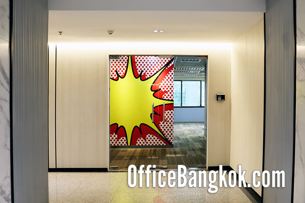 Spacious partly furnished office for rent near BTS Chidlom, featuring natural light, private meeting rooms, and a professional working atmosphere.